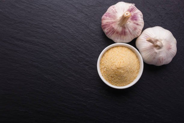 fragrant garlic on a dark stone background.